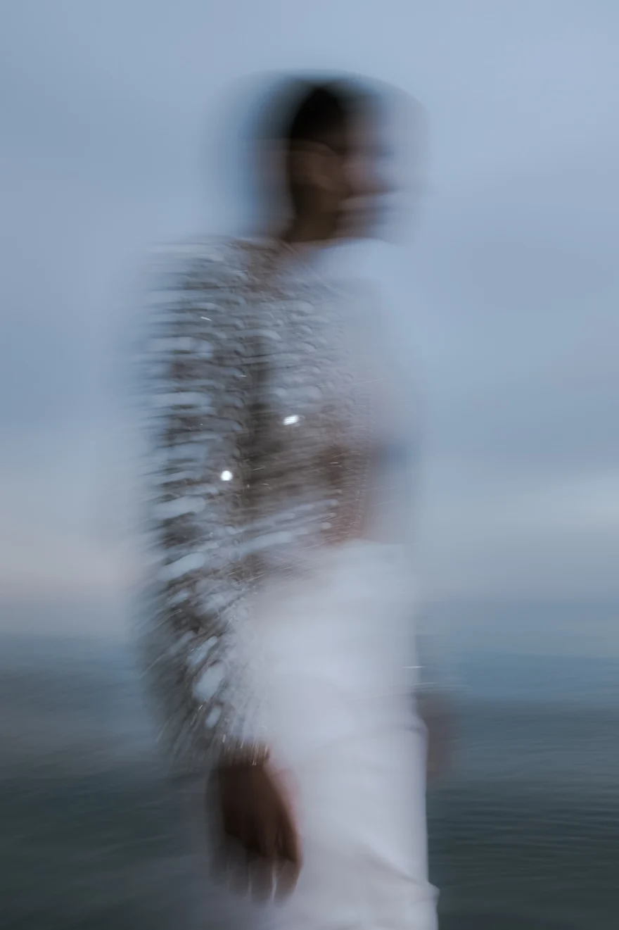 Long-exposure figure dissolving against the sea at dusk, ETRO × SHOT Magazine editorial photographed by Ina Cenusa