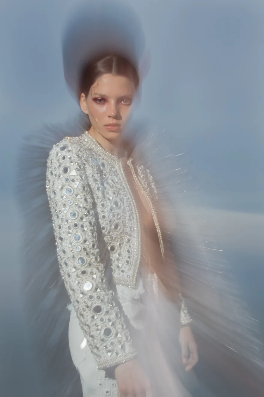 Mirror-embellished jacket caught in motion against a pale sky, ETRO × SHOT Magazine editorial photographed by Ina Cenusa