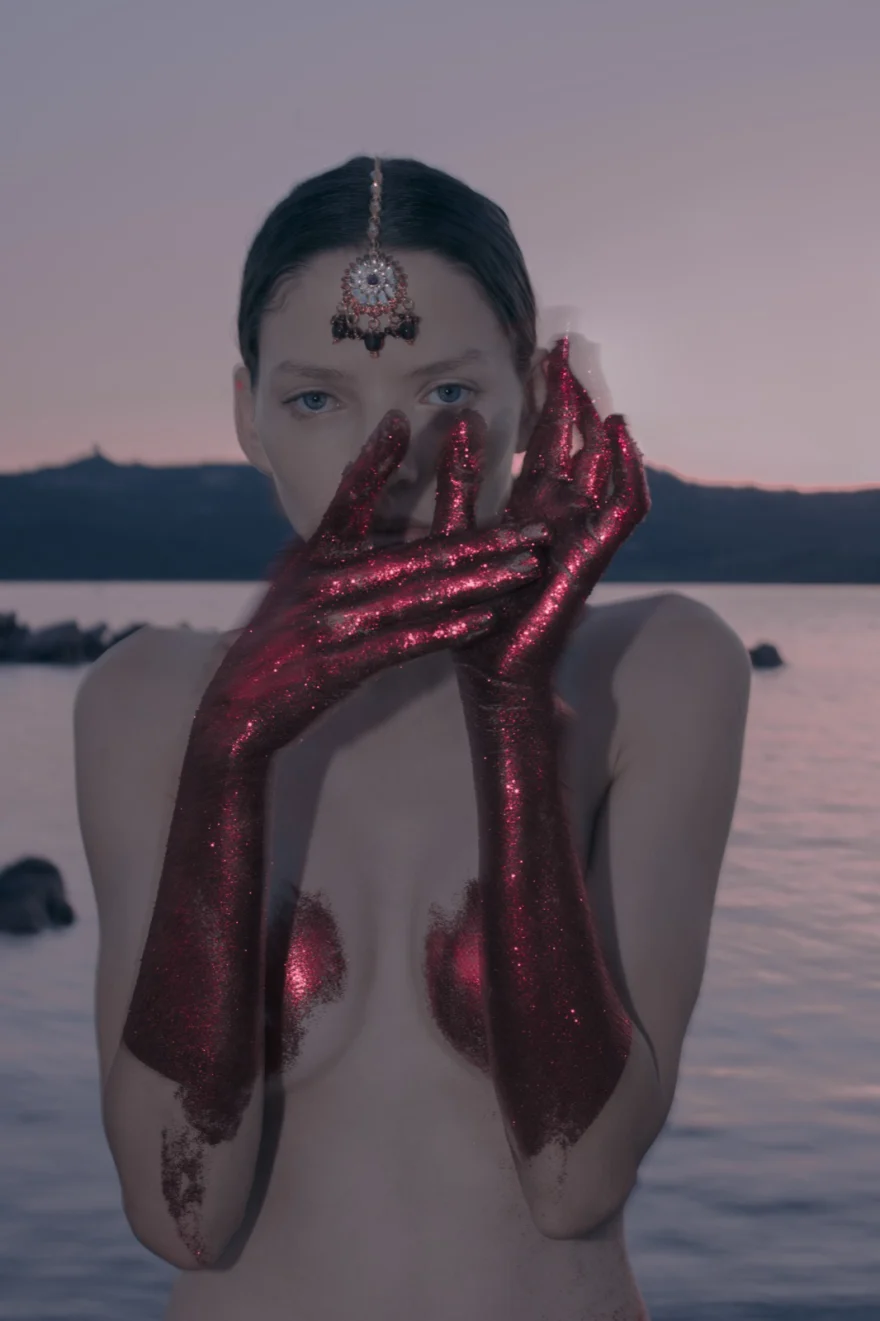 Portrait with hands painted deep red raised to the face at dusk, closing image of the story, ETRO × SHOT Magazine editorial photographed by Ina Cenusa