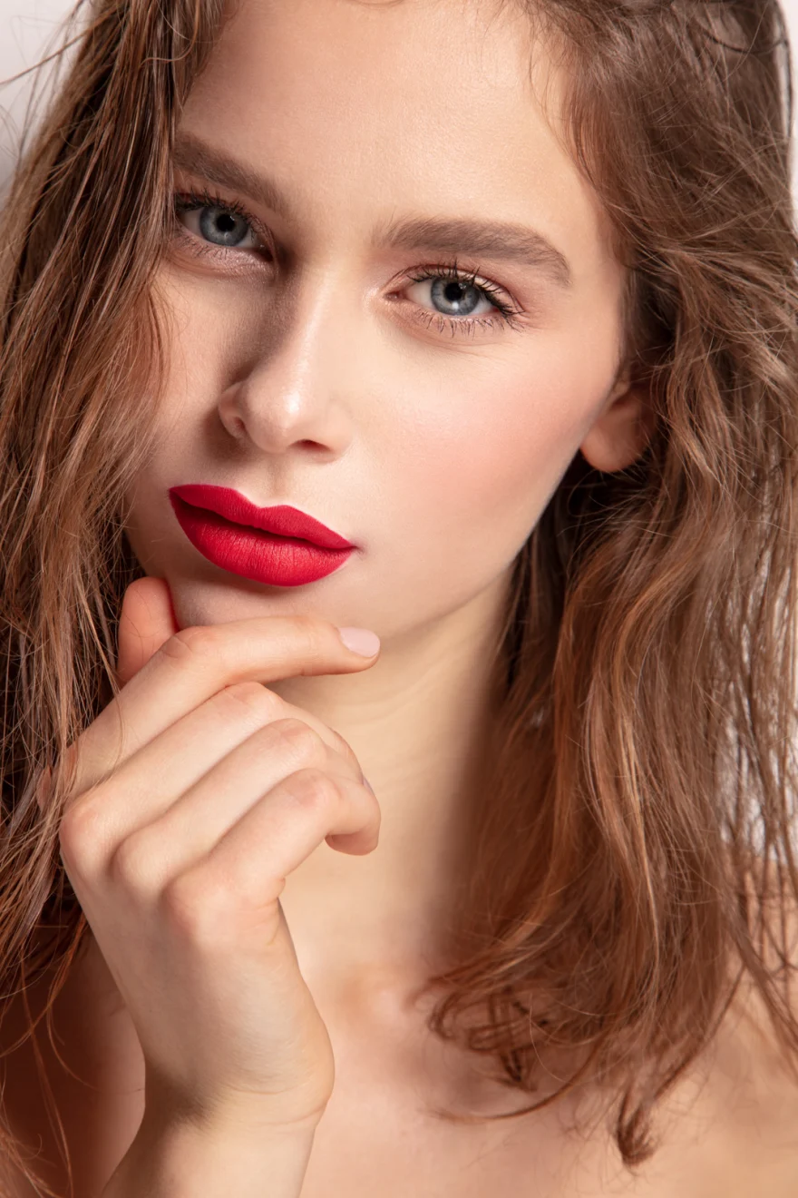 Beauty portrait with red lipstick and a hand resting under the chin, Philip Martin's campaign photographed by Ina Cenusa