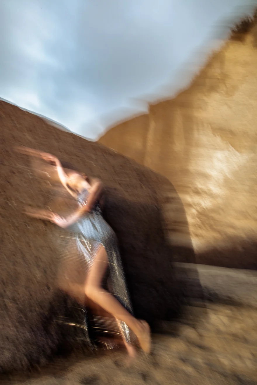 Motion-blurred figure against volcanic rock and sky, Sabina in Tenerife personal project photographed by Ina Cenusa