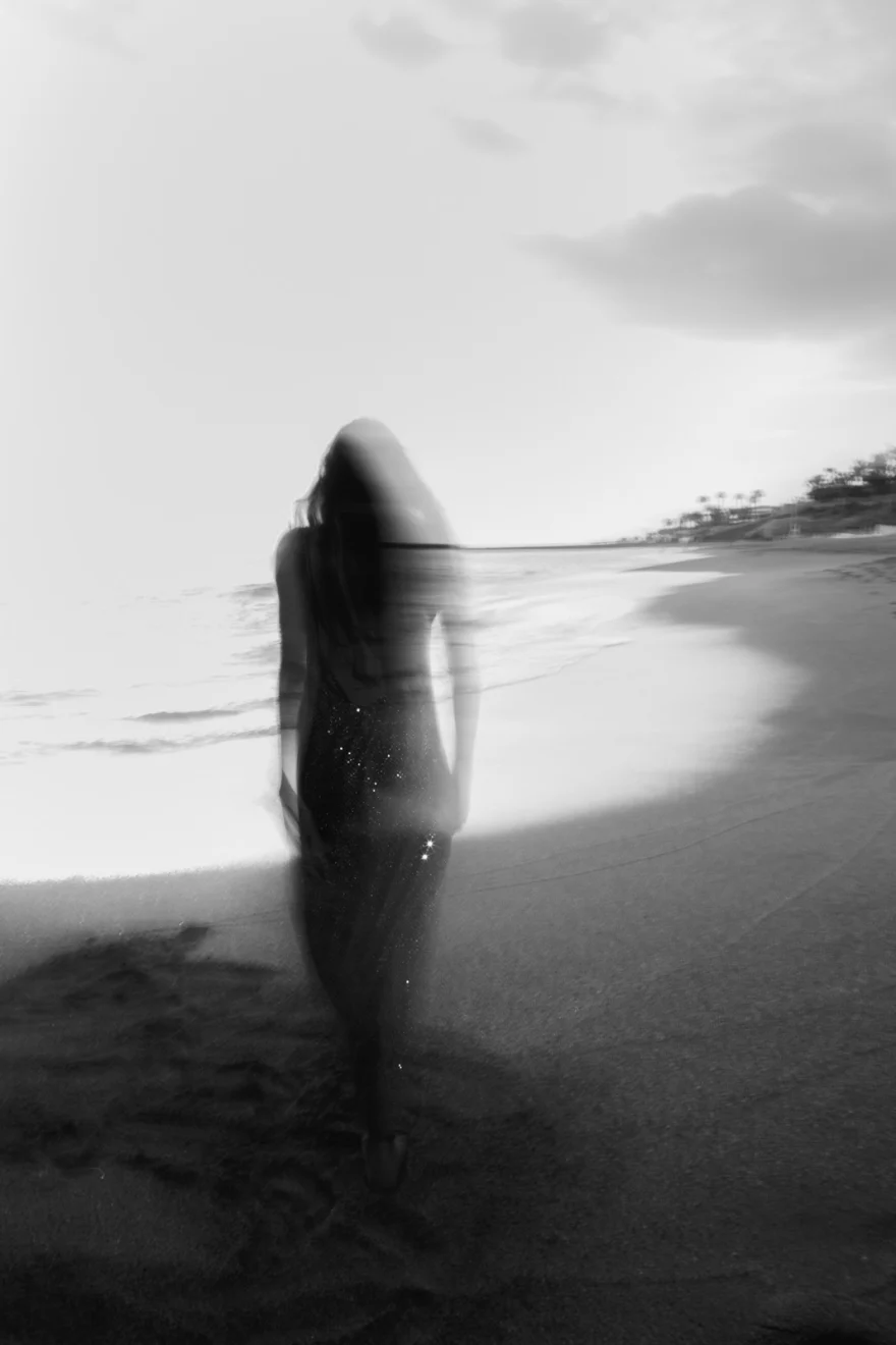 Black and white long-exposure figure on the shore, closing image of the story, Sabina in Tenerife personal project photographed by Ina Cenusa