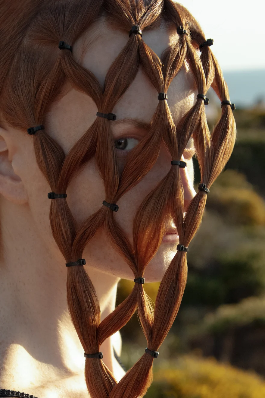Close-up of red hair braided into a lattice veil across the face, SHOT Magazine editorial photographed by Ina Cenusa