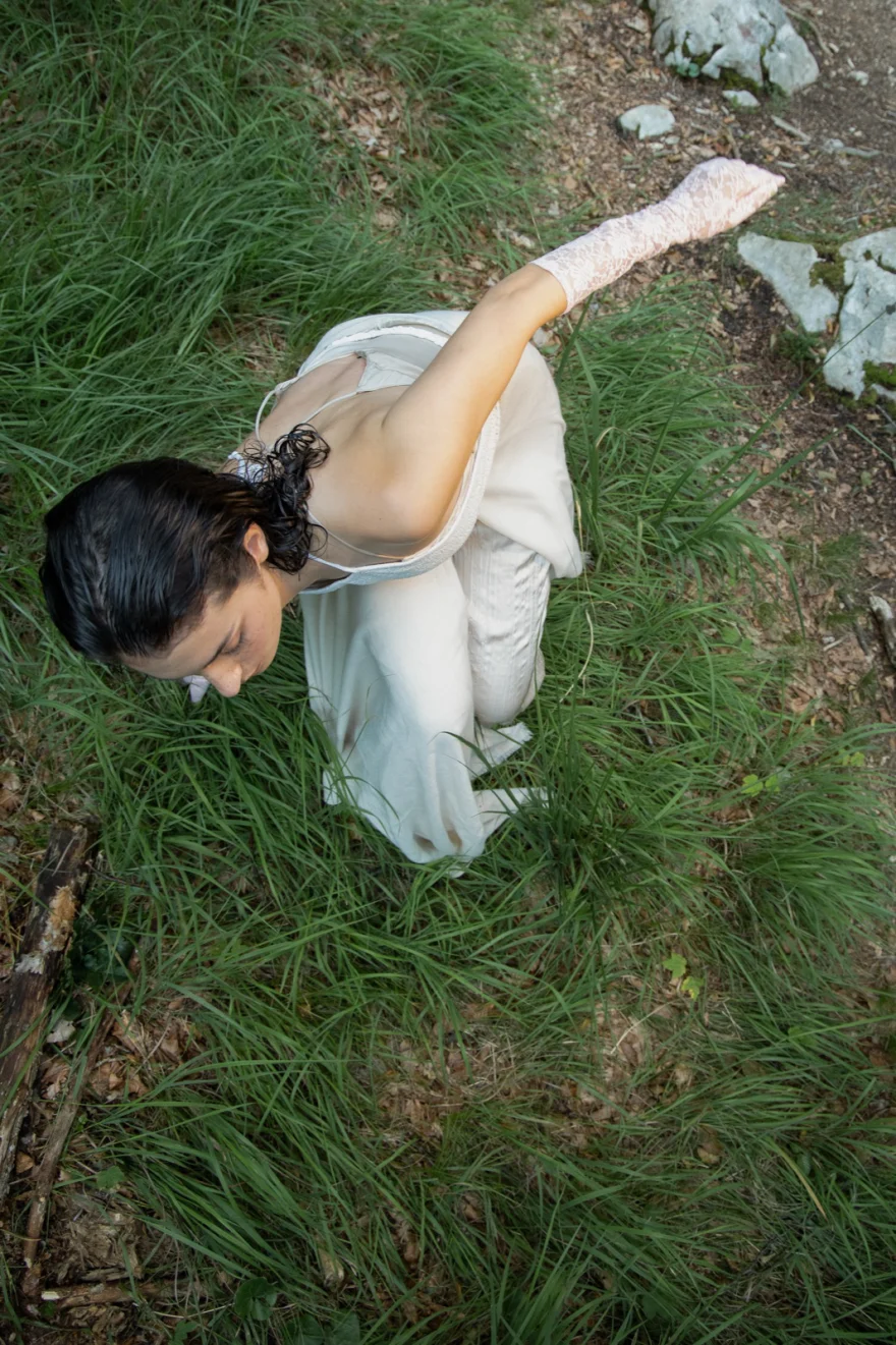 Overhead view of the model bending in the grass, closing image of Radici, SHOT Magazine editorial photographed by Ina Cenusa