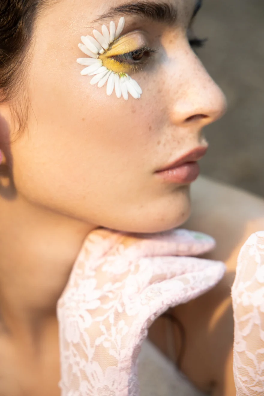 Beauty close-up with a daisy placed under the eye and a lace glove, SHOT Magazine editorial photographed by Ina Cenusa