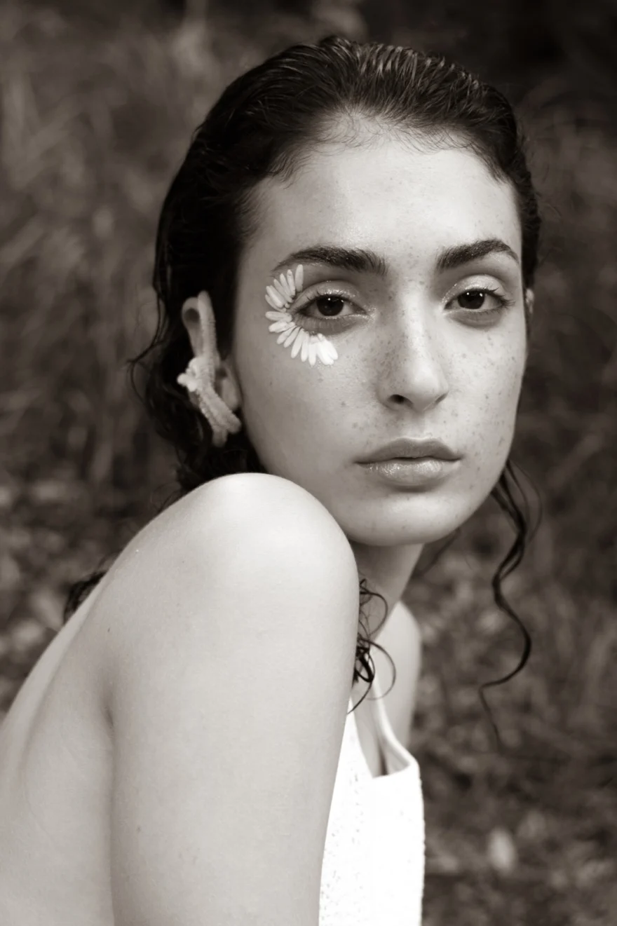 Black and white portrait with a daisy tucked behind the ear, SHOT Magazine editorial photographed by Ina Cenusa
