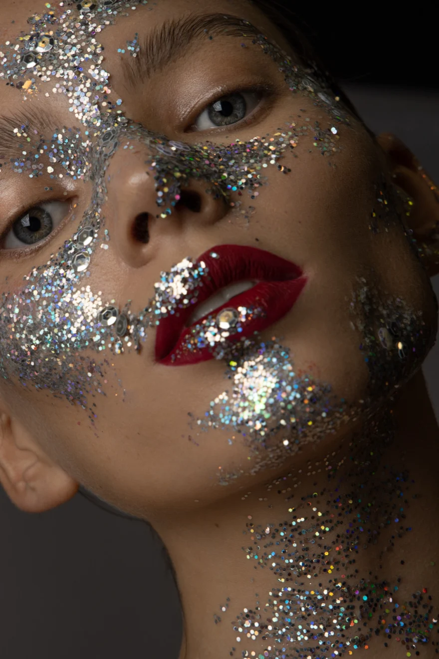 Close-up beauty shot of silver glitter make-up and glossy red lips, Iso Model Management editorial photographed by Ina Cenusa