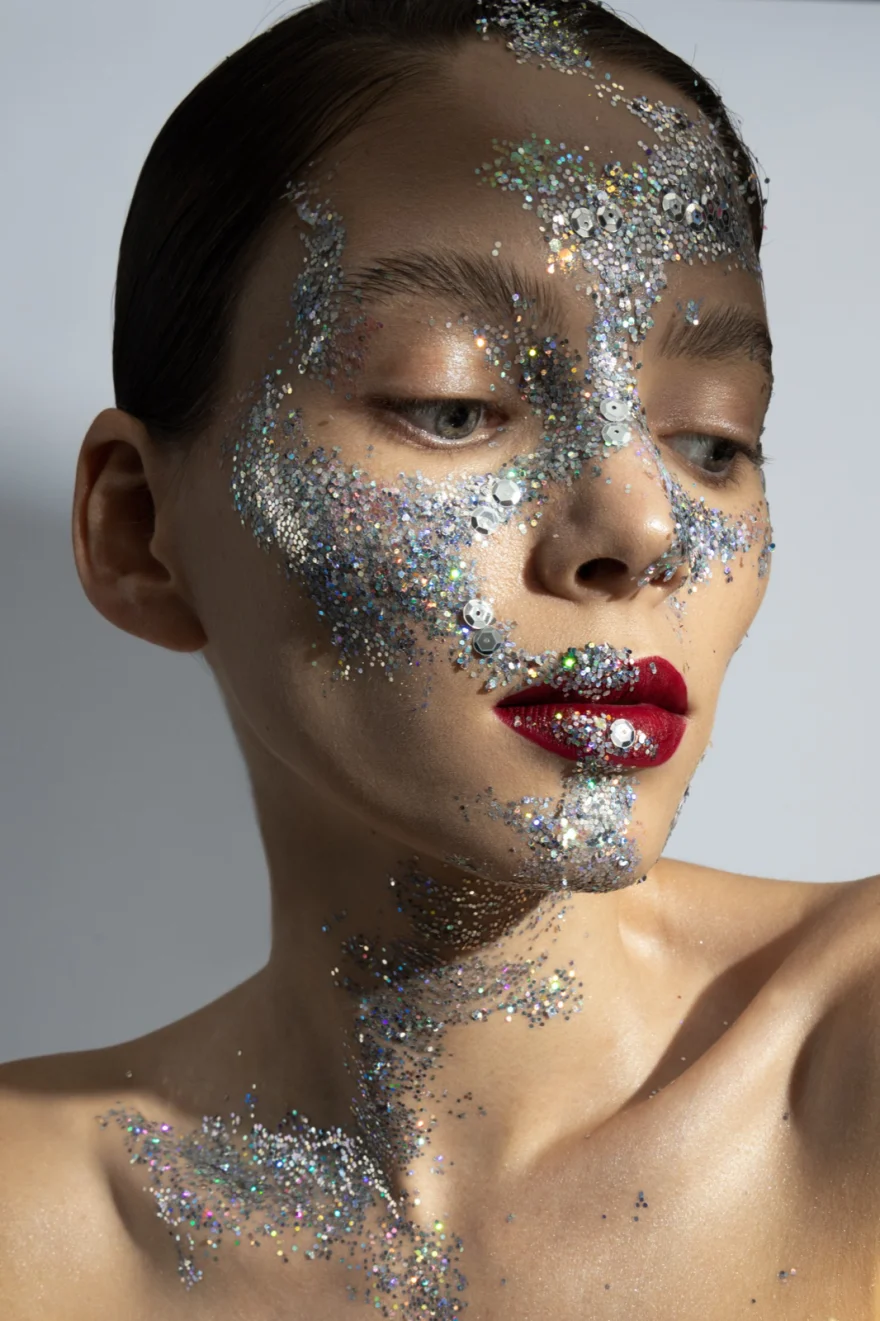 Beauty portrait with silver glitter across the face and red lips, Iso Model Management editorial photographed by Ina Cenusa