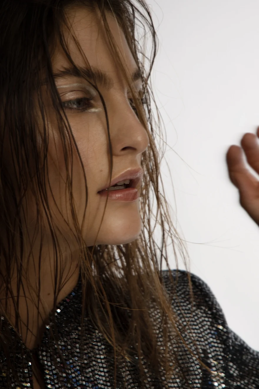 Profile portrait with wet-look hair over a sequinned top, Iso Model Management editorial photographed by Ina Cenusa