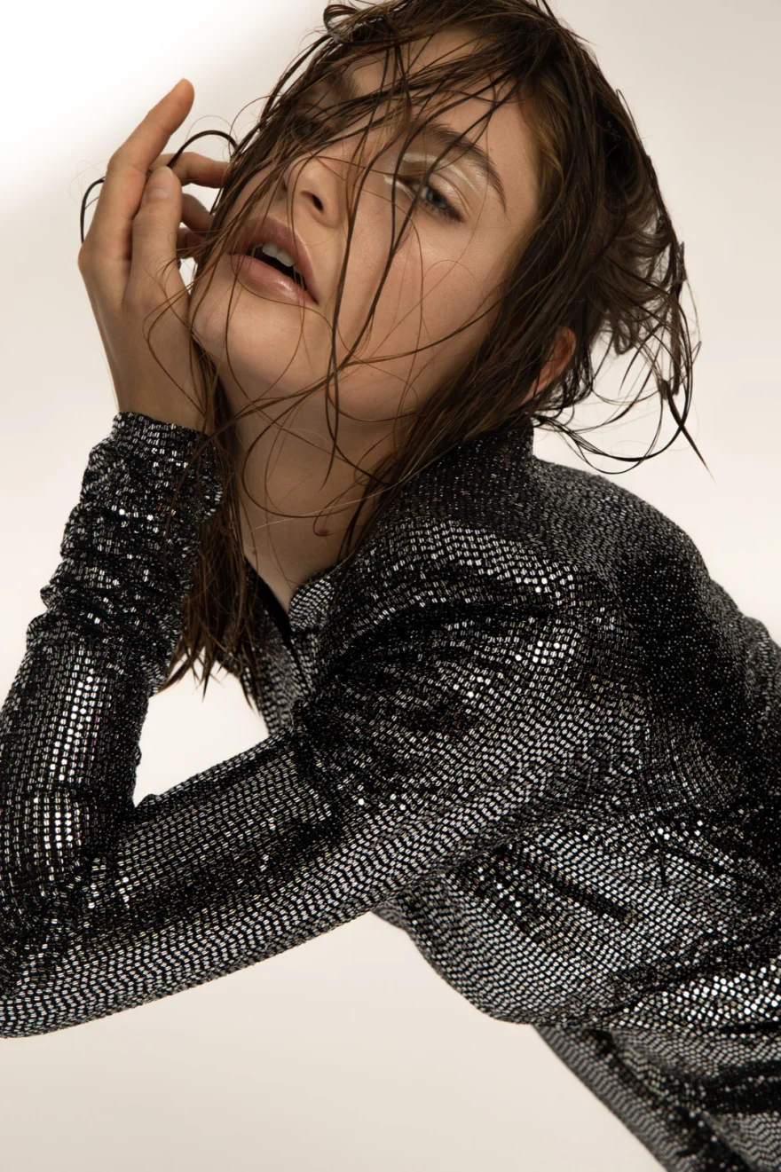 Studio portrait in a sequinned dress with a hand raised to the face, Iso Model Management editorial photographed by Ina Cenusa