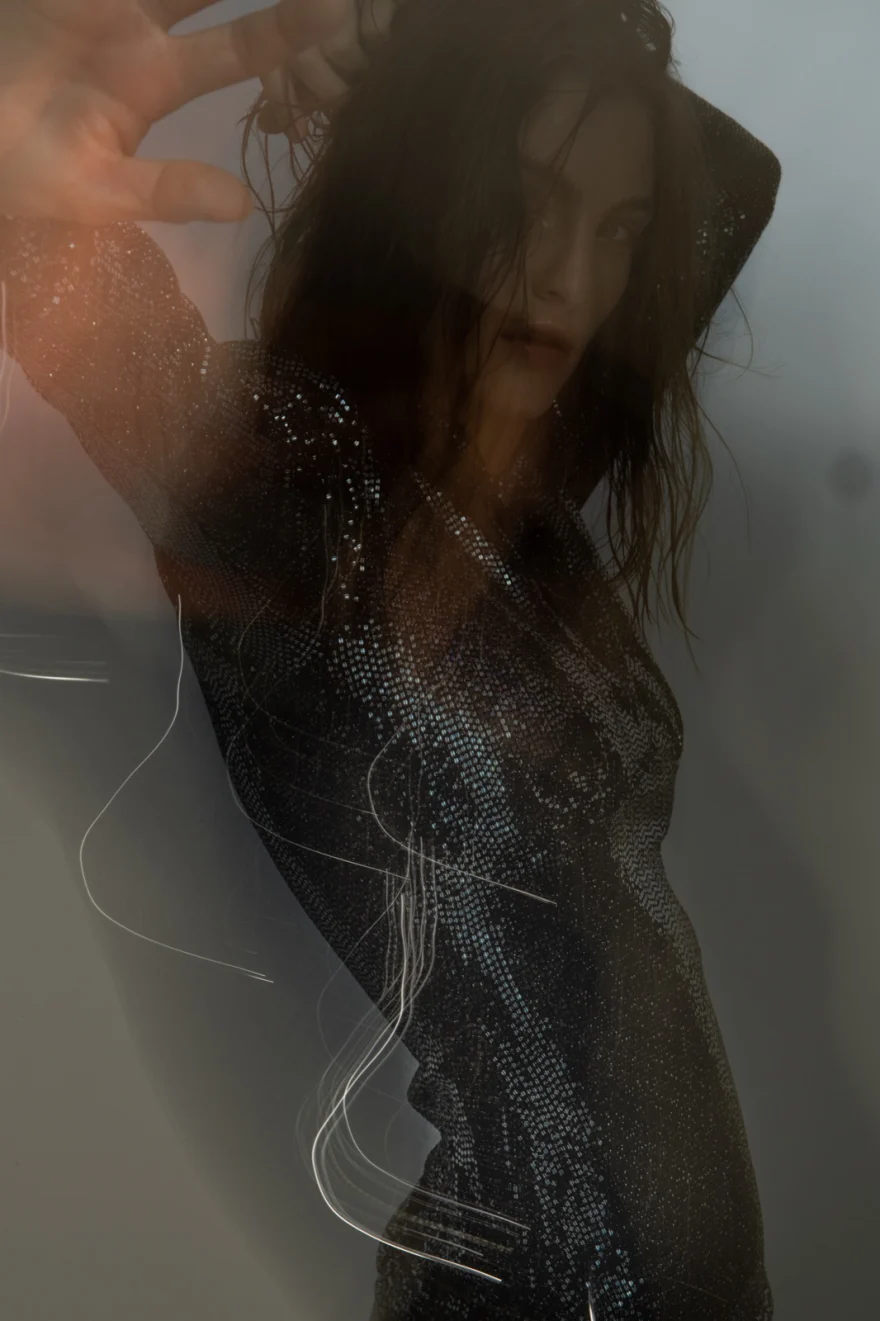 Motion-blurred studio portrait in a sparkling dress, Iso Model Management editorial photographed by Ina Cenusa