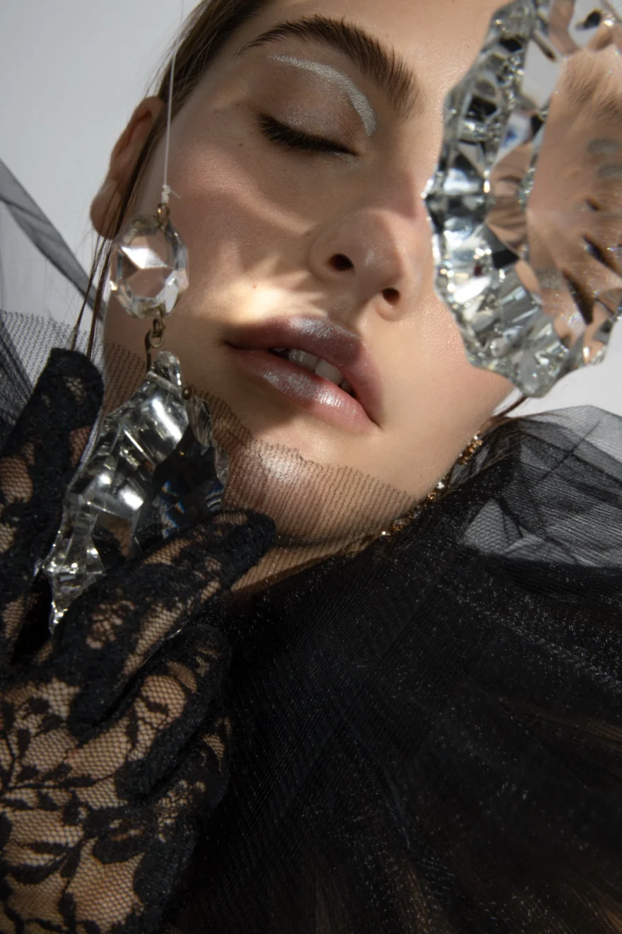 Close-up with silver foil against the face and black lace gloves, Iso Model Management editorial photographed by Ina Cenusa