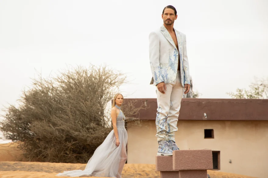 Two models on a low desert wall at golden hour, Philip Martin's campaign photographed by Ina Cenusa