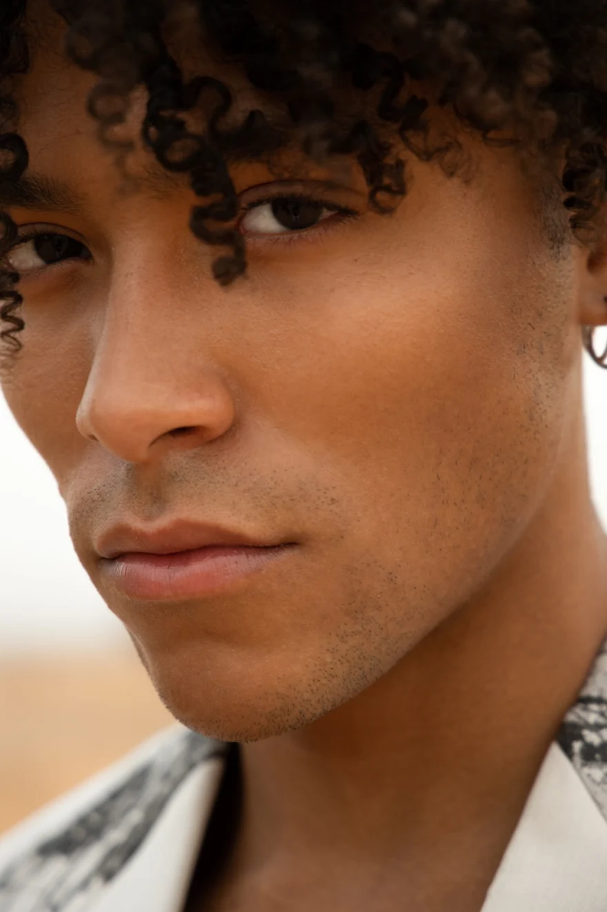 Close-up portrait of a model with sculpted curly hair, Philip Martin's campaign photographed by Ina Cenusa