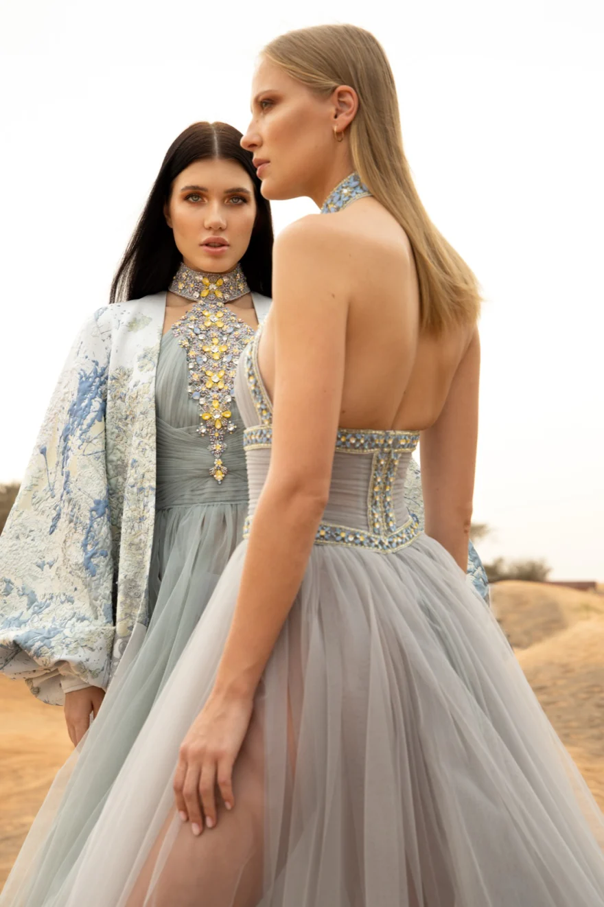 Two models in embroidered tulle gowns in the desert, Philip Martin's campaign photographed by Ina Cenusa