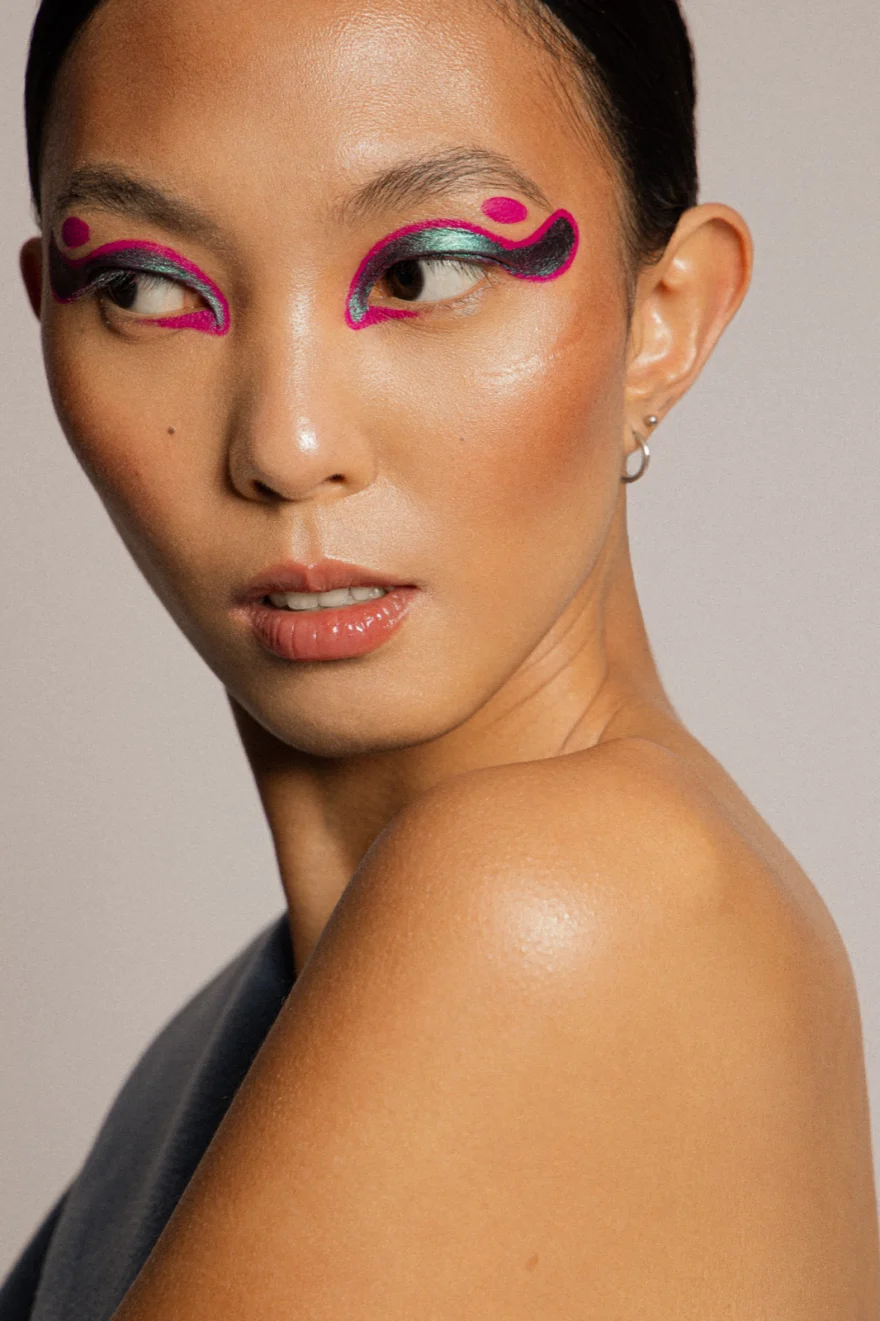 Beauty portrait looking over the shoulder with graphic eye make-up, LYX Magazine editorial photographed by Ina Cenusa