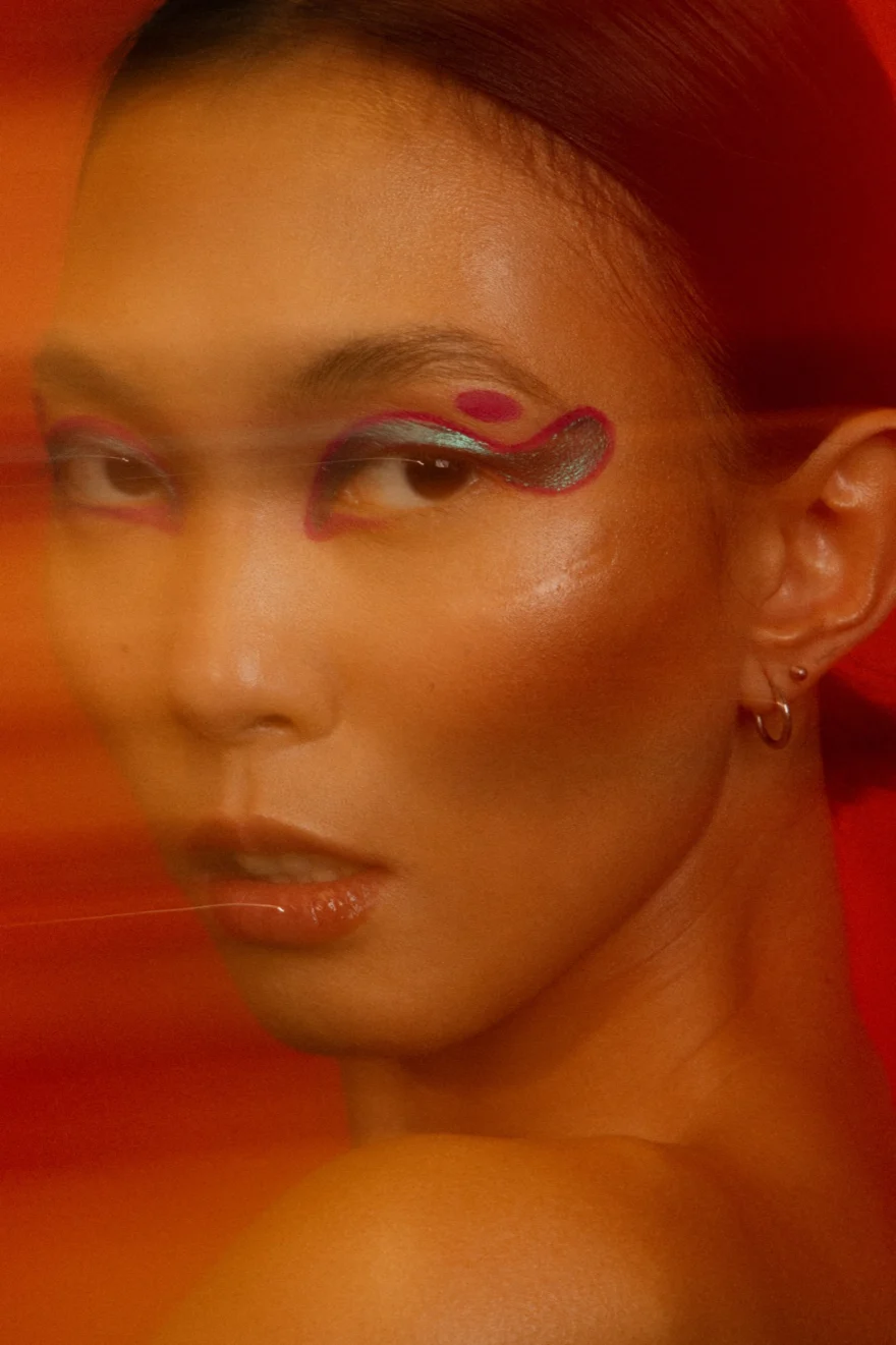 Portrait with graphic eye make-up seen through a red haze, LYX Magazine editorial photographed by Ina Cenusa