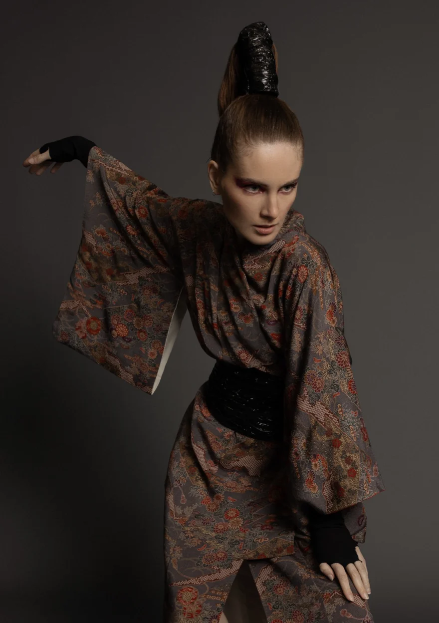 Model in a patterned kimono coat with one arm raised, sculptural updo, Hunter Magazine editorial photographed by Ina Cenusa