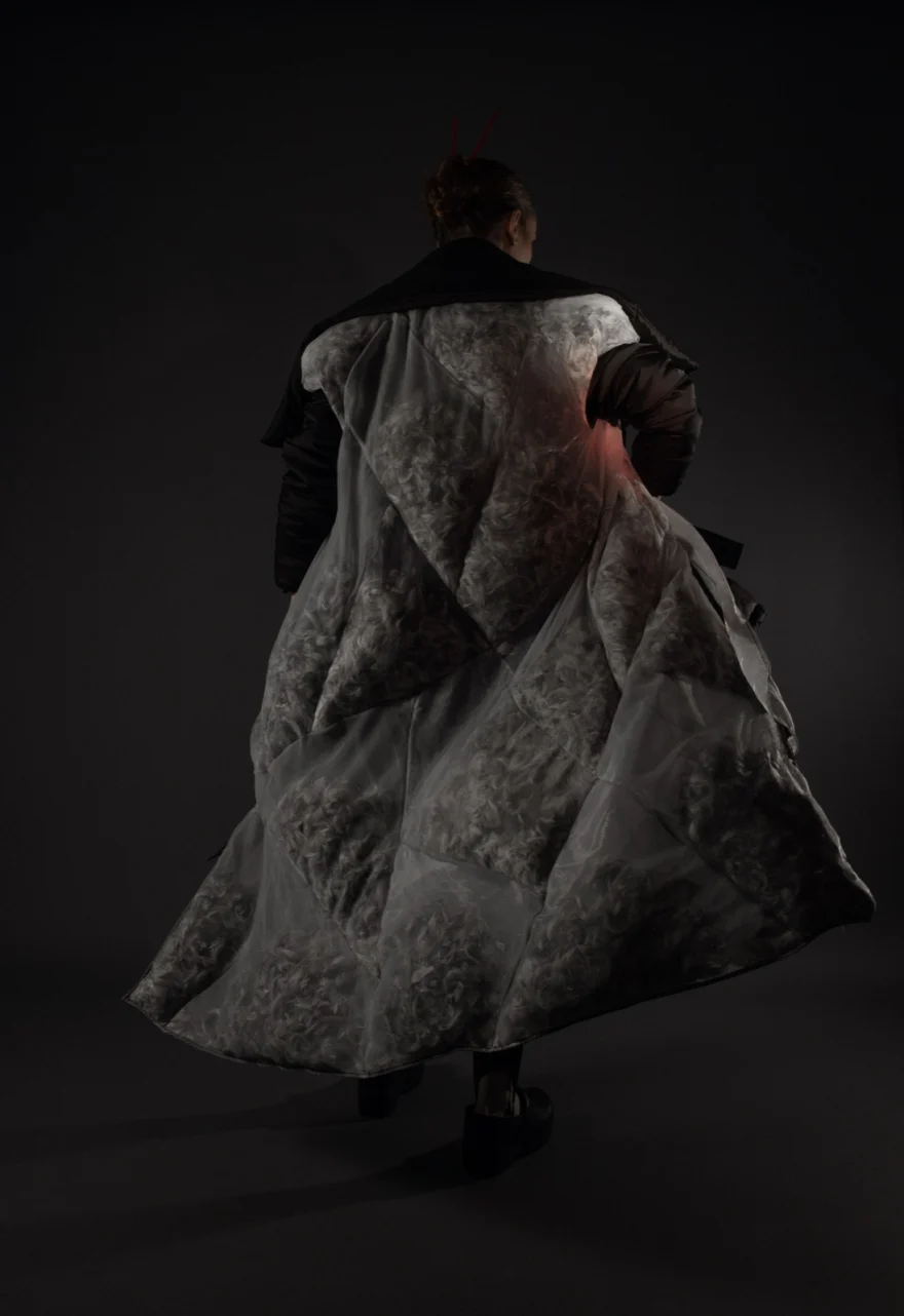 Back view of a voluminous quilted coat sweeping across the studio floor, Hunter Magazine editorial photographed by Ina Cenusa