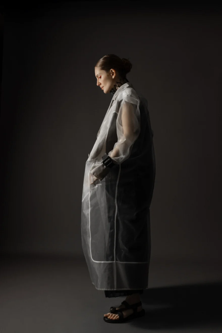 Figure in a padded jacket dissolving into saturated red light, closing image of Human Darkness, Hunter Magazine editorial photographed by Ina Cenusa