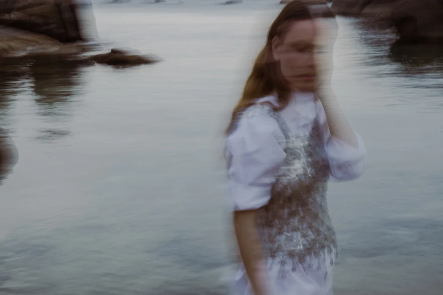 Motion-blurred figure wading into the sea, closing image of Foreign Lilies, SHOT Magazine editorial photographed by Ina Cenusa