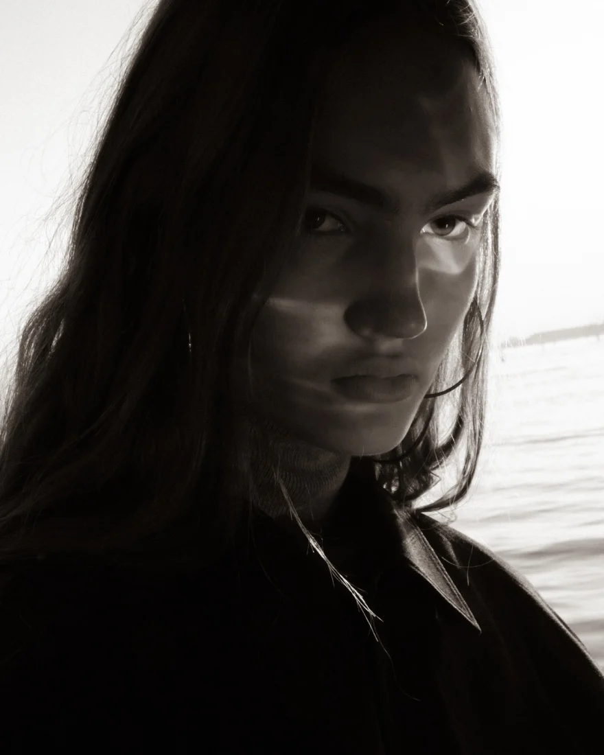 Close portrait with a band of light falling across the face, Daria personal project photographed by Ina Cenusa