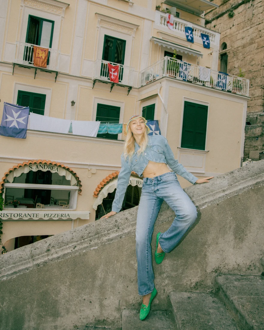 Model in denim on a stone stairway among the village facades of Amalfi, commercial fashion shoot, Luca Grassi campaign photographed by Ina Cenusa