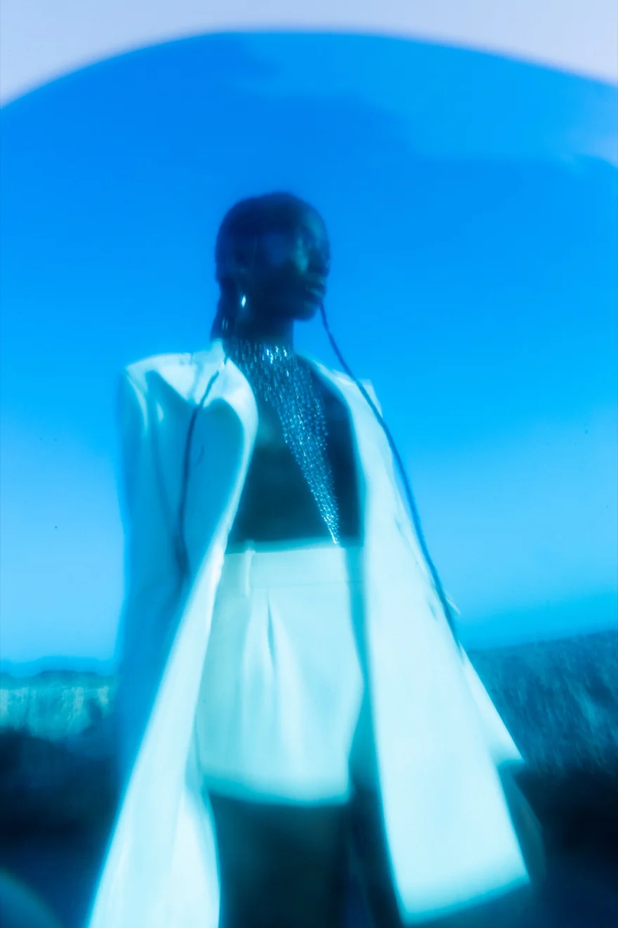 Close-up of a green puffer jacket over a sequinned top with beaded braids, Ermanno Scervino × SHOT Magazine editorial photographed by Ina Cenusa