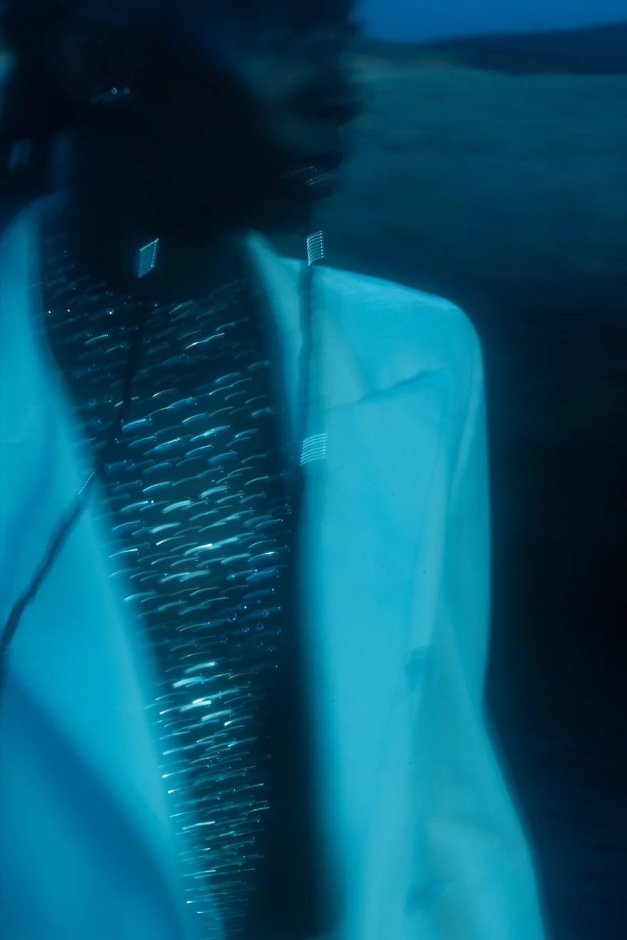 Blurred night portrait of a white jacket over a silver sequinned top, Ermanno Scervino × SHOT Magazine editorial photographed by Ina Cenusa
