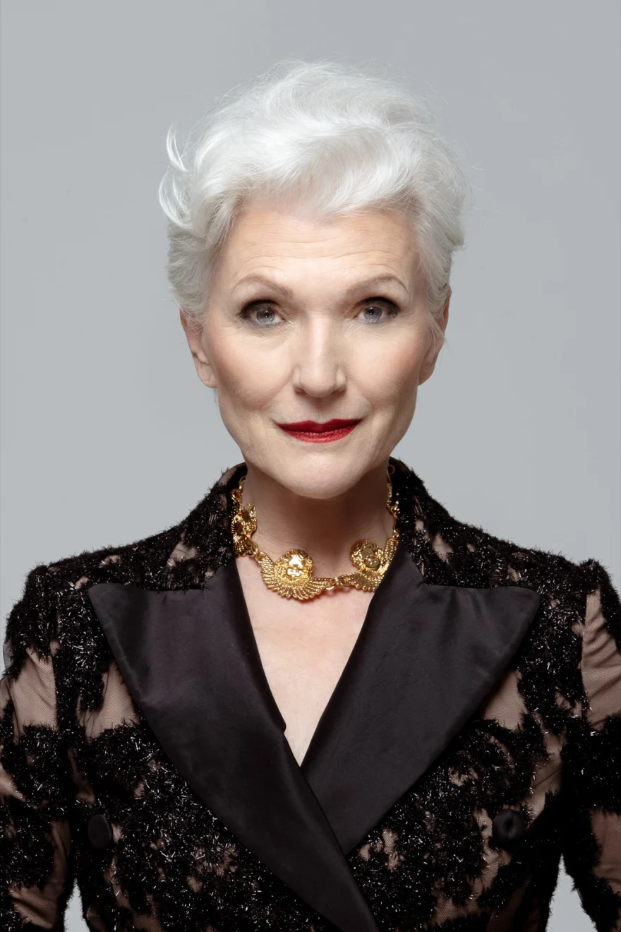 Close portrait of Maye Musk in a black lace blazer with satin lapels and a gold chain necklace, SHOT Magazine campaign photographed by Ina Cenusa