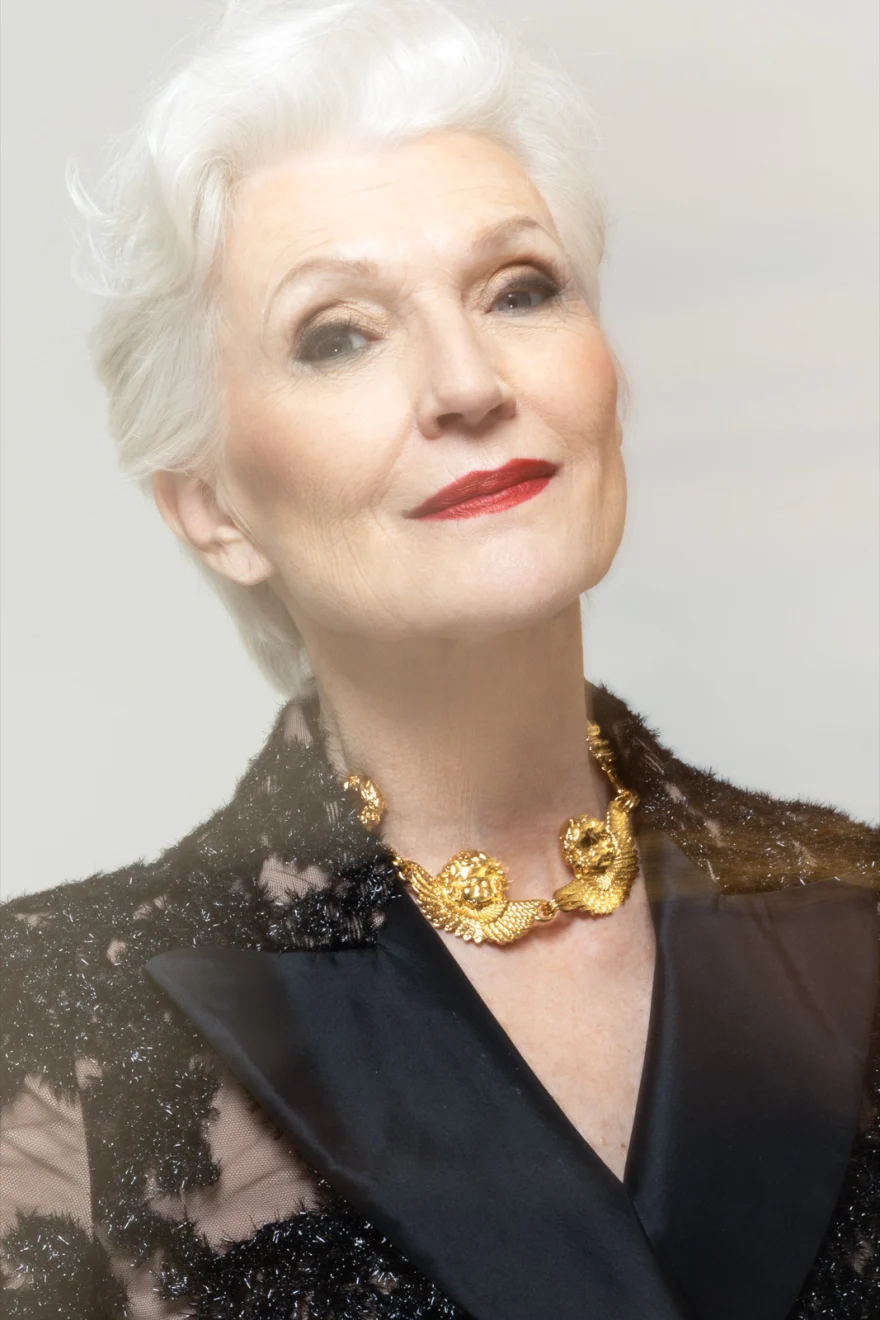 Portrait of Maye Musk smiling in a lace blazer with a heavy gold necklace, SHOT Magazine campaign photographed by Ina Cenusa