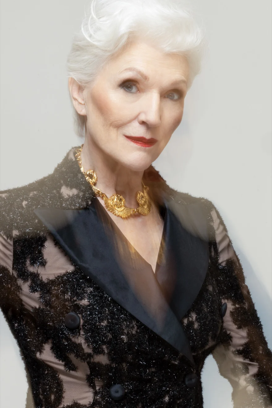 Three quarter portrait of Maye Musk in a lace blazer, hand on hip, SHOT Magazine campaign photographed by Ina Cenusa