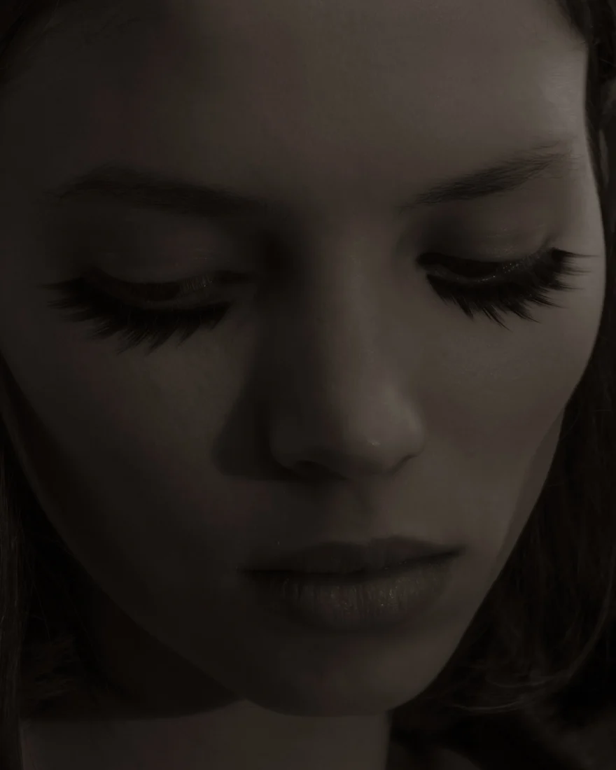 Beauty close-up with long lashes and lowered eyes in dim light, Sabina personal project photographed by Ina Cenusa