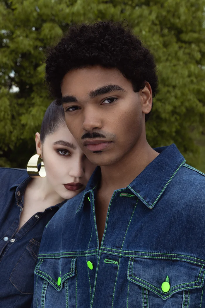 Close portrait of two models in denim jackets with green hardware details, Carrera Jeans campaign photographed by Ina Cenusa