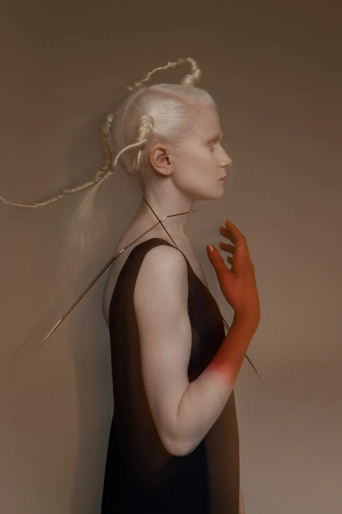 Red-painted hand resting against the model's face in warm light, SHOT Magazine editorial photographed by Ina Cenusa