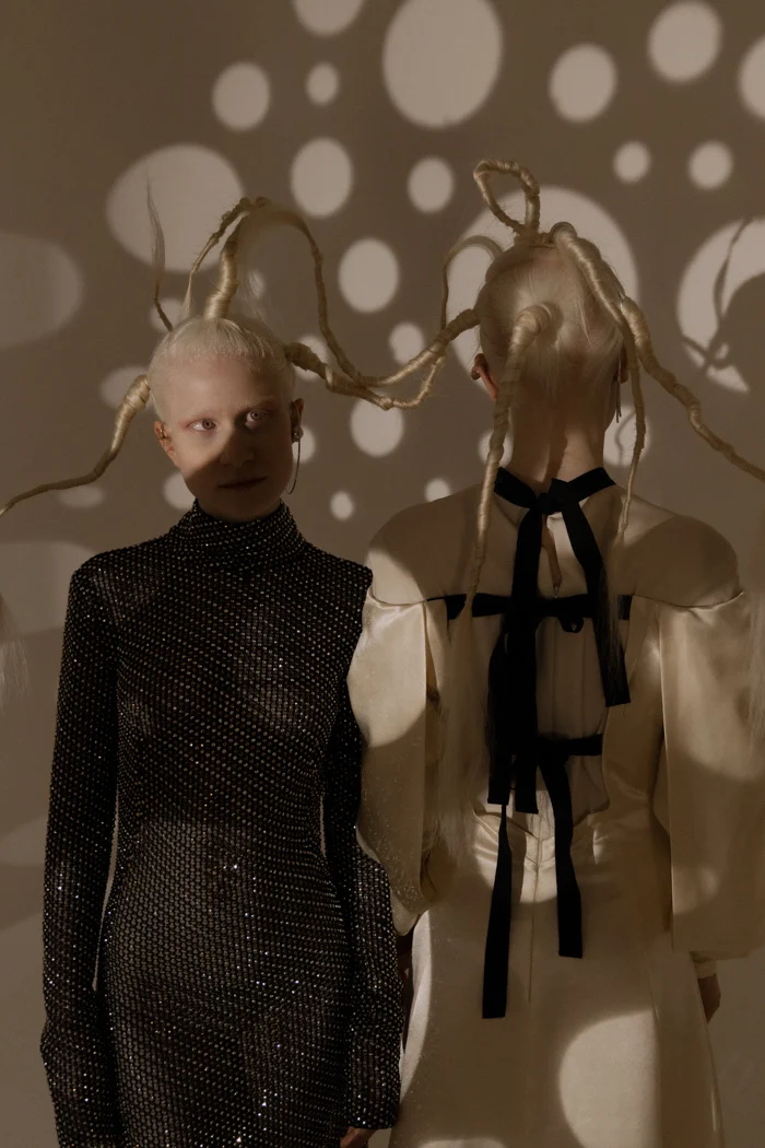 Two models standing under a projection of light circles, SHOT Magazine editorial photographed by Ina Cenusa