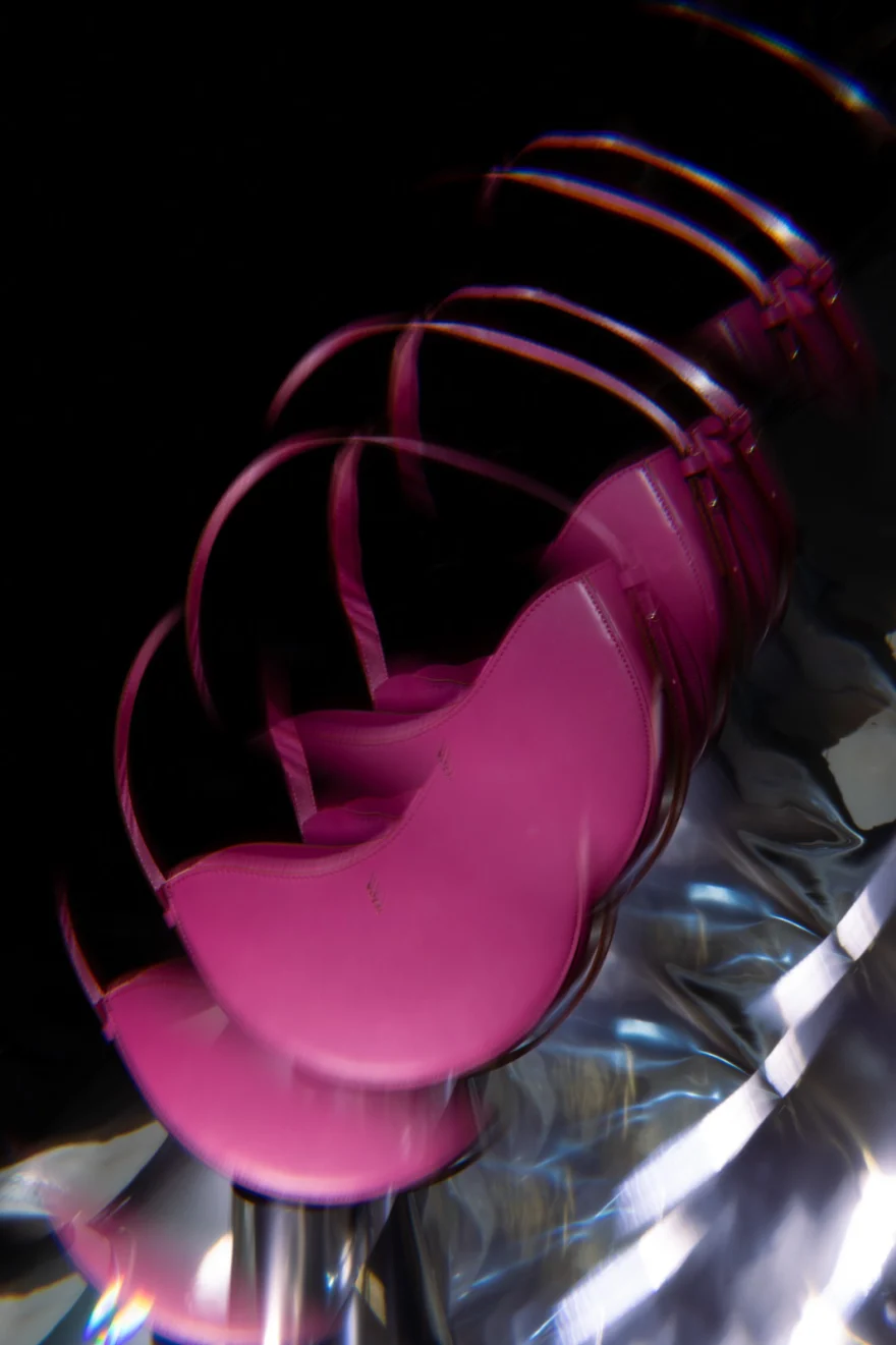 Long-exposure trails of a pink leather bag on a stool, Noesi campaign photographed by Ina Cenusa