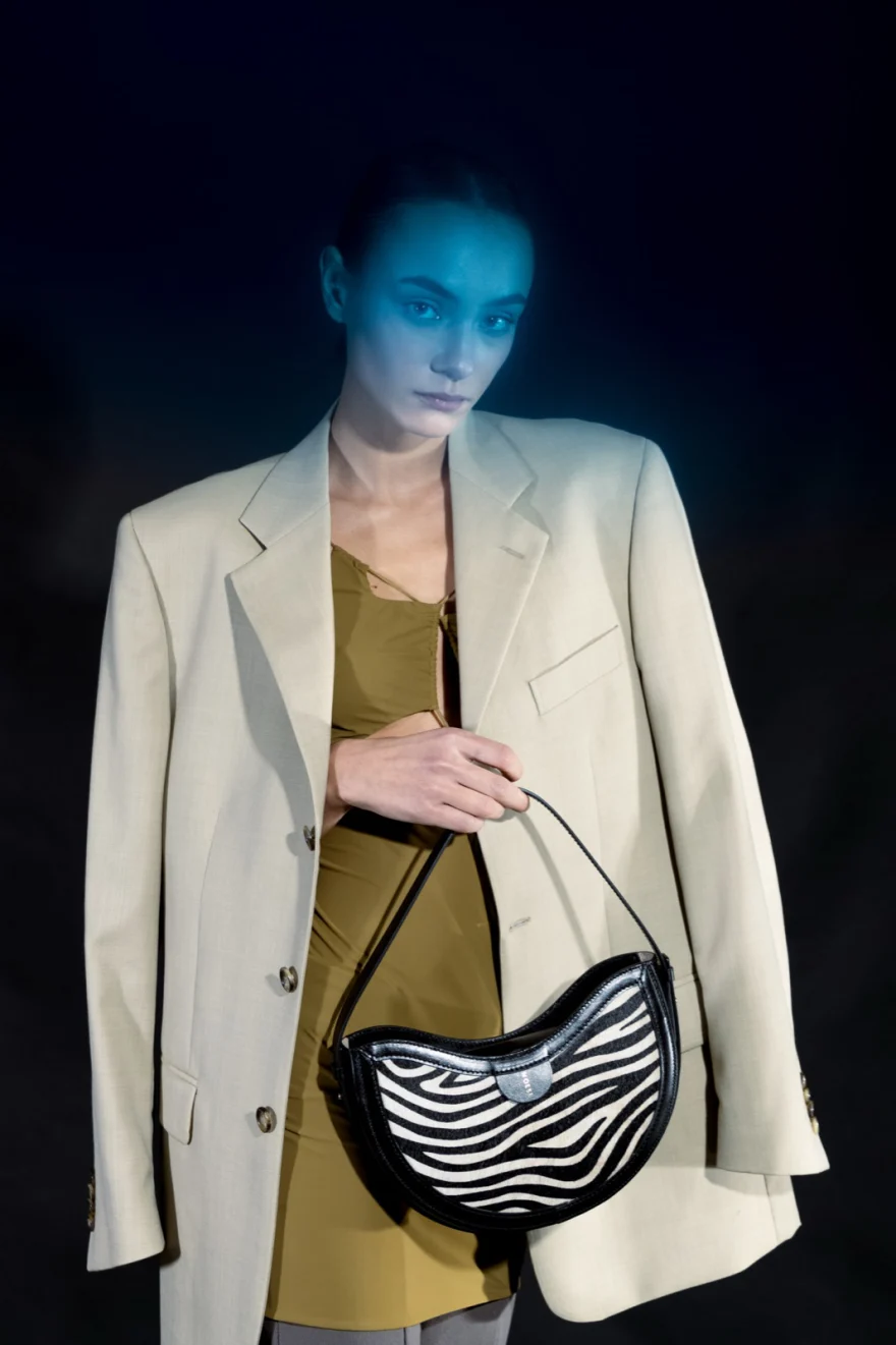 Model in a cream blazer with a zebra-print shoulder bag, Noesi campaign photographed by Ina Cenusa