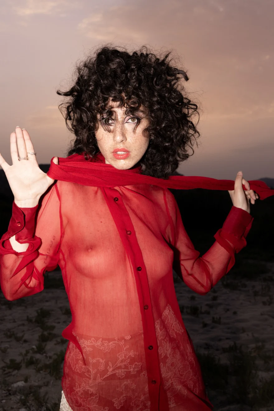 Model holding a red sheer scarf outstretched at dusk, Authenticity editorial for SHOT Magazine, photographed by Ina Cenusa