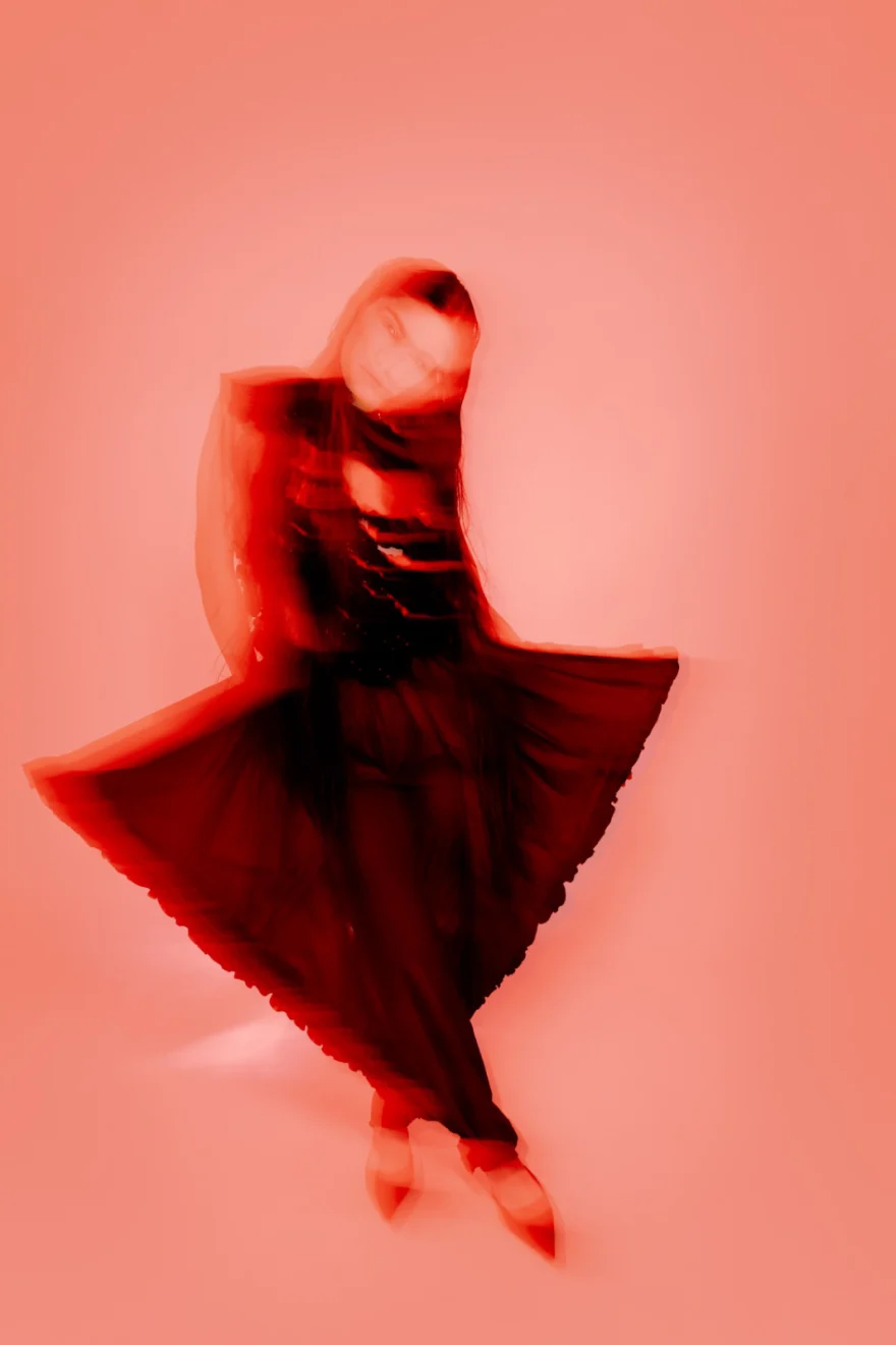 Motion-blurred fashion portrait of a model dancing in a red dress, SHOT Magazine editorial photographed by Ina Cenusa