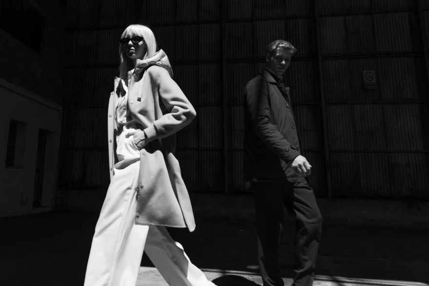 Black and white shot of two models in outerwear on an industrial street, Mabrun campaign photographed by Ina Cenusa