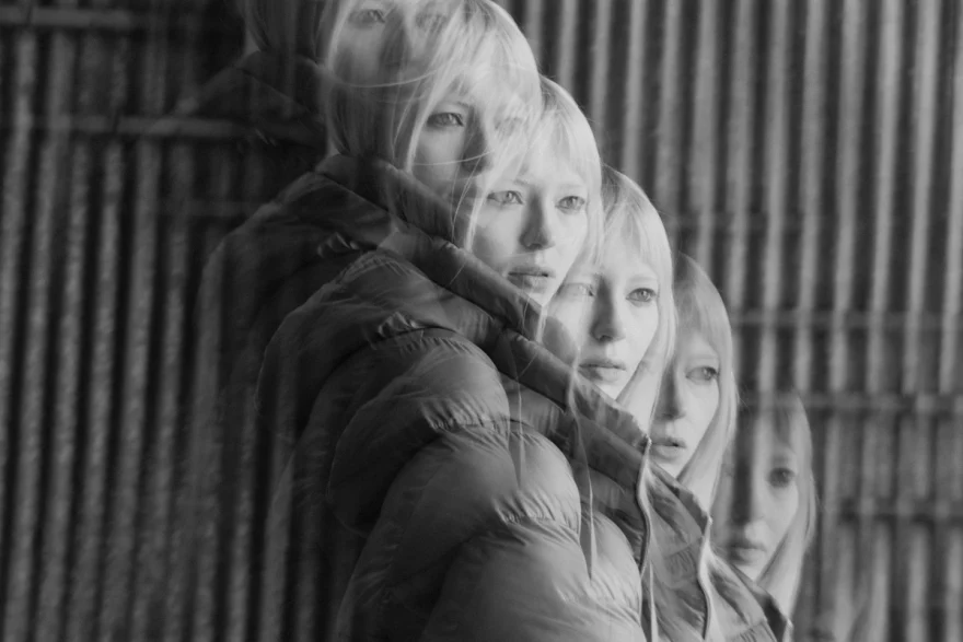 Multiple-exposure black and white portrait in a padded coat, Mabrun campaign photographed by Ina Cenusa