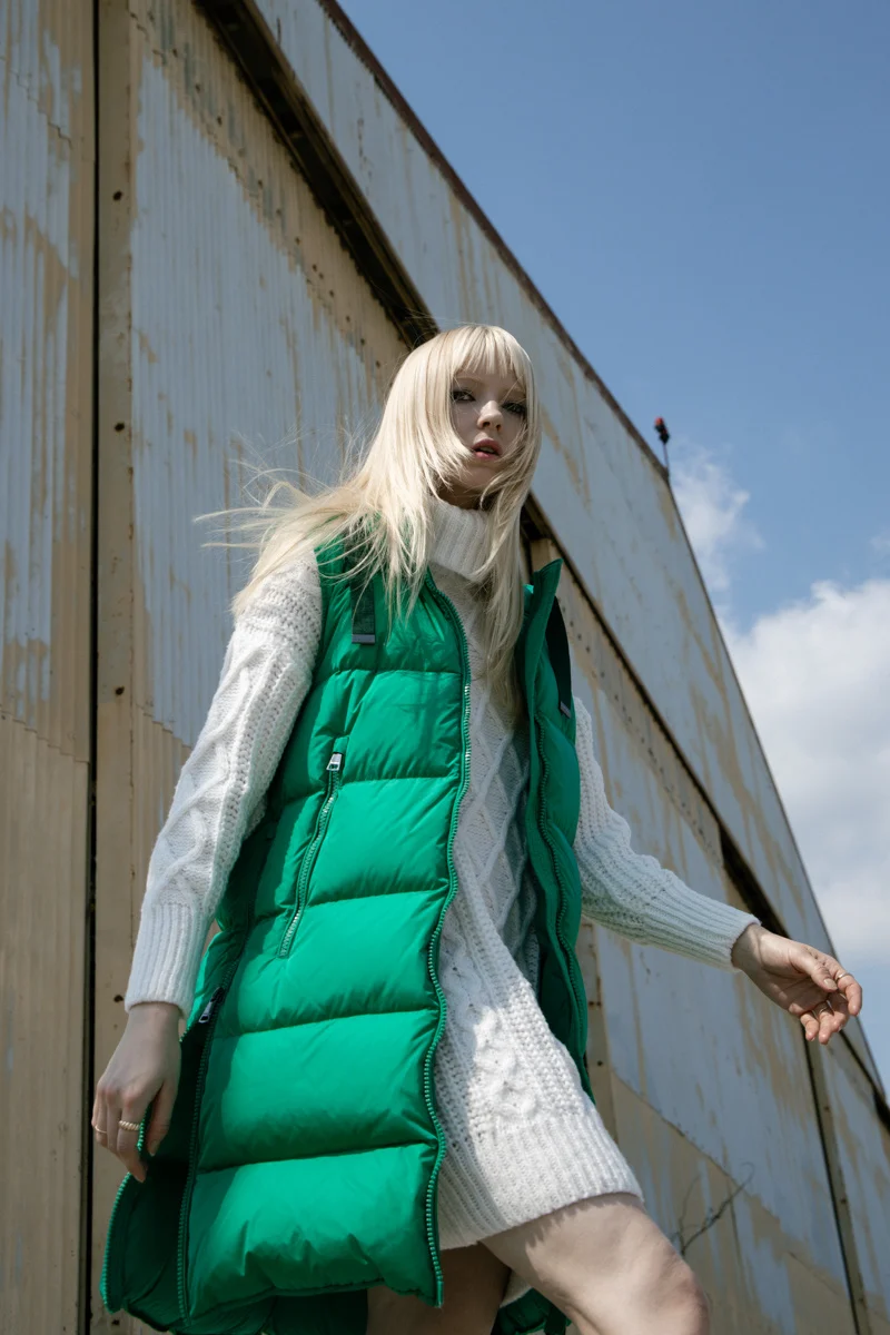 Model in a green padded gilet against a weathered wall, Mabrun campaign photographed by Ina Cenusa