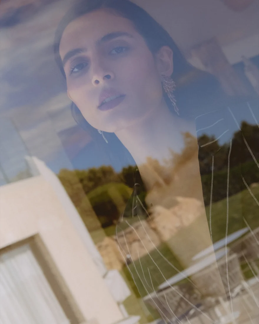 Portrait seen through a window with the garden reflected on the glass, SHOT Magazine editorial photographed by Ina Cenusa