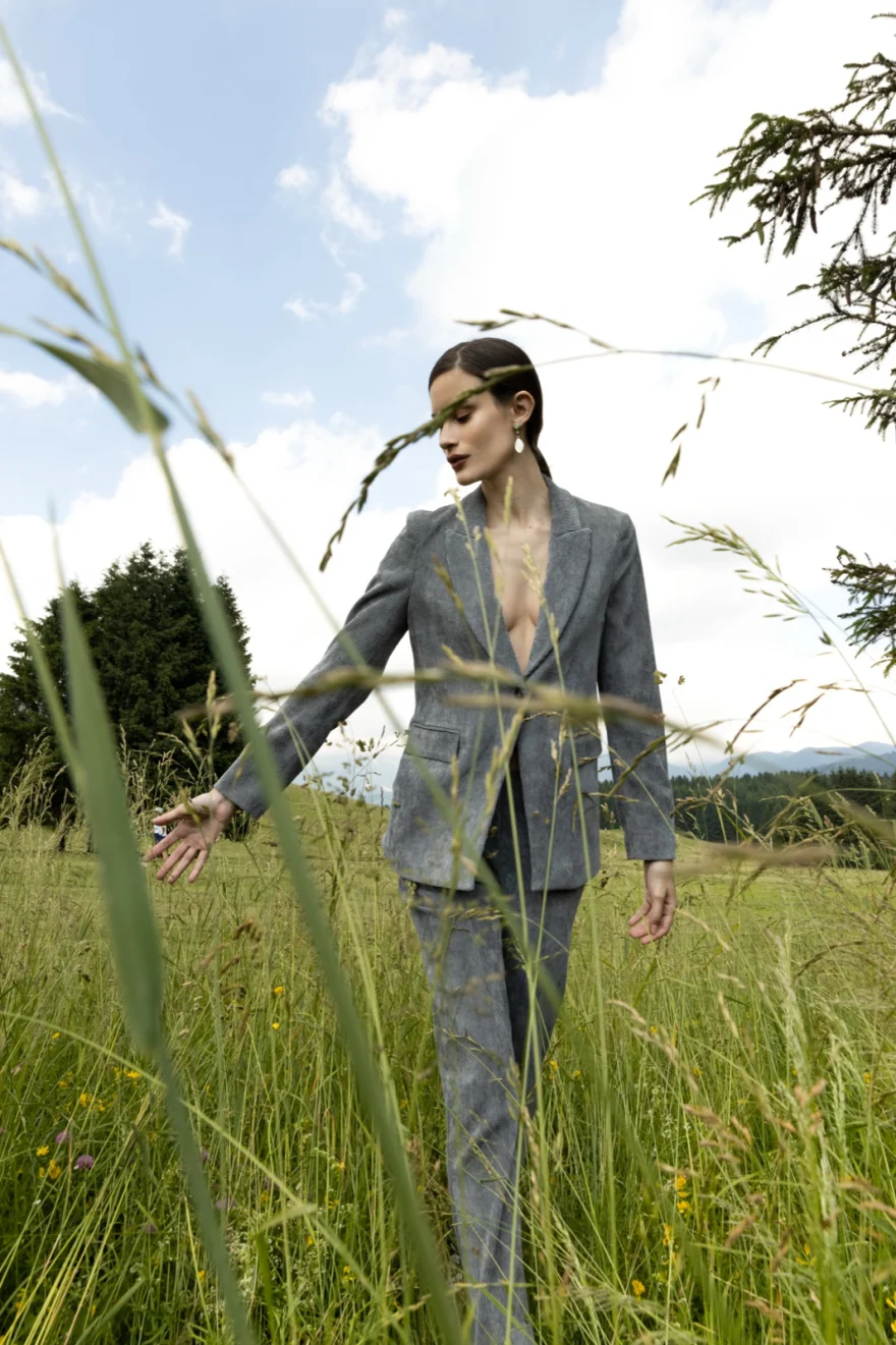 Model in a tweed suit in a mountain meadow, Camicetta Snob campaign photographed by Ina Cenusa