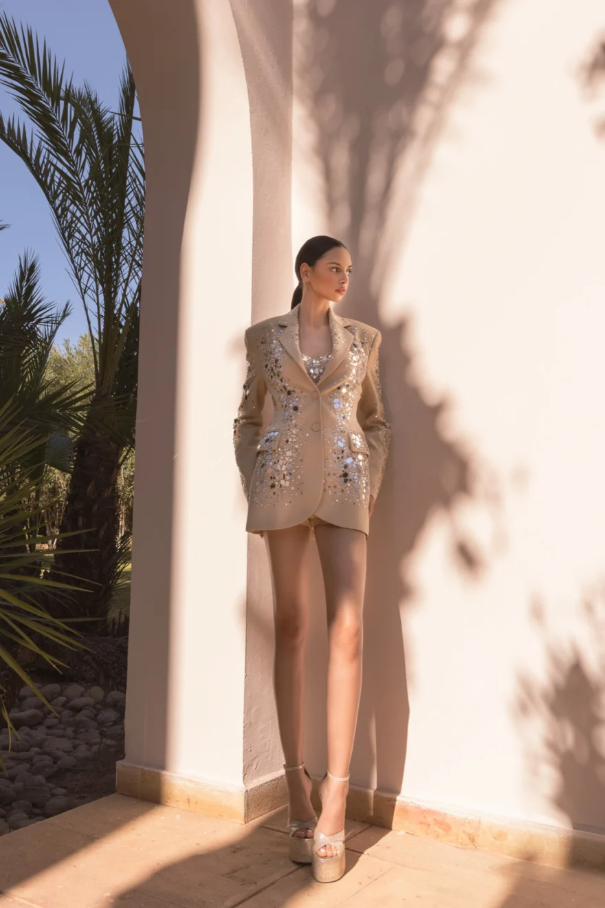 Model in white beneath the arches of a riad courtyard, Ermanno Scervino campaign photographed by Ina Cenusa