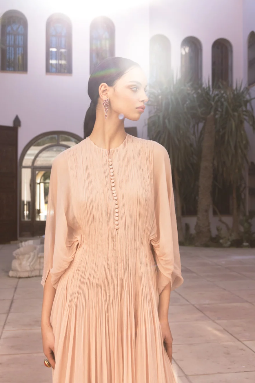 Model in a white tiered dress in a sunlit corridor, Ermanno Scervino campaign photographed by Ina Cenusa