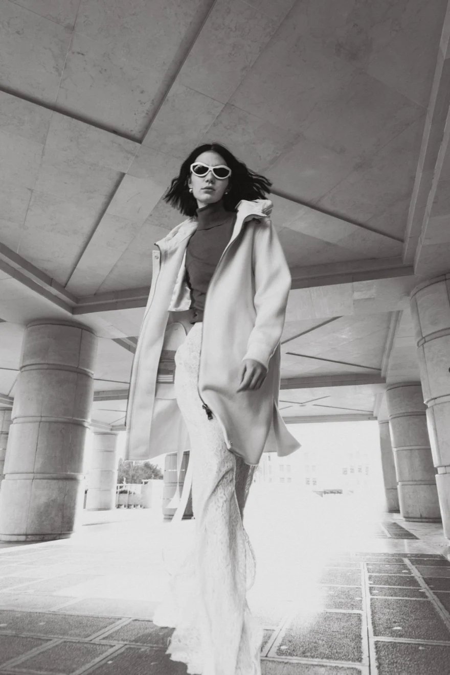 Model in a long pale coat under a Venetian portico, Mabrun campaign photographed by Ina Cenusa