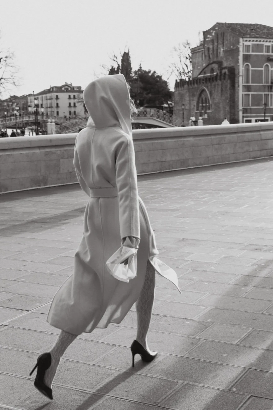 Model in a hooded coat walking a Venetian fondamenta, Mabrun campaign photographed by Ina Cenusa