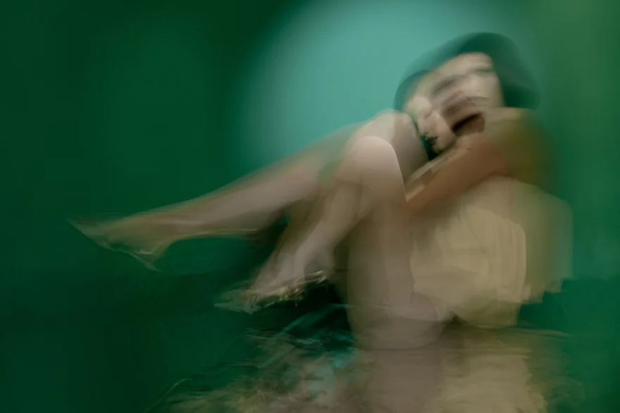 Motion-blurred seated figure with knees drawn up, SHOT Magazine editorial photographed by Ina Cenusa
